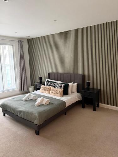 a bedroom with a bed with two towels on it at Apartment in the heart of Cardiff City Centre in Cardiff