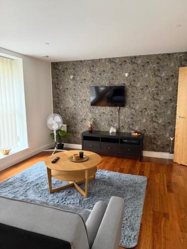 a living room with a couch and a table at Apartment in the heart of Cardiff City Centre in Cardiff