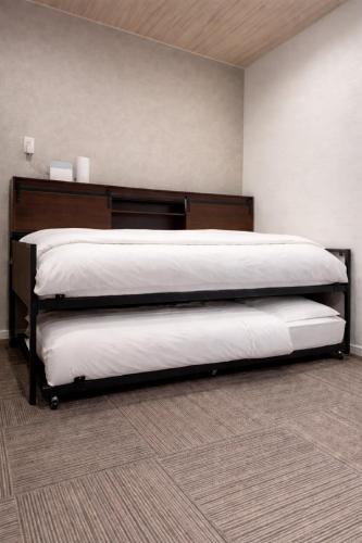 a bedroom with a large bed in a room at Room One in Aomori