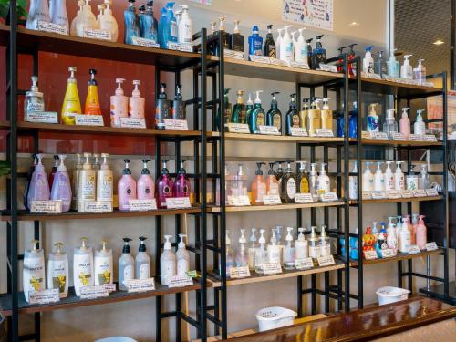 a room filled with shelves filled with lots of bottles at Yatsushiro Grand Hotel in Yatsushiro