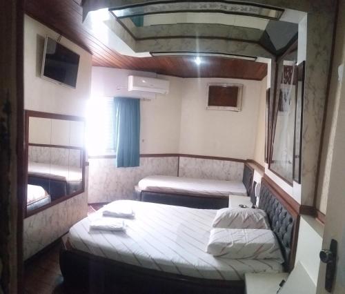 a small room with two beds in it at Hotel Flor da Vila Mariana in Sao Paulo