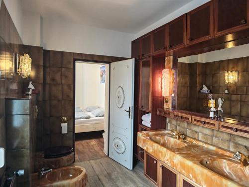 a bathroom with a large sink and a bedroom at Pension Highway - Osnabrück Klarastr 11 in Osnabrück