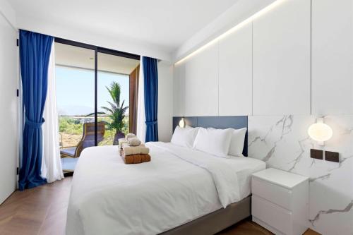 a bedroom with a bed with a teddy bear on it at Sunshine Beach Layan by Beringela in Layan Beach