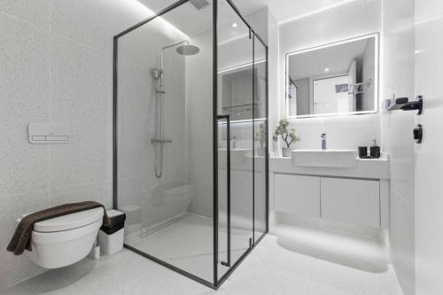 a bathroom with a shower and a toilet and a sink at Sunshine Beach Layan by Beringela in Layan Beach