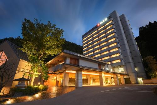a large building is lit up at night at Yumoto Kissho in Osaki