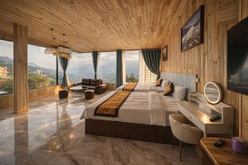 a bedroom with a large bed in a room with windows at Sapa May Ecolodge in Sapa