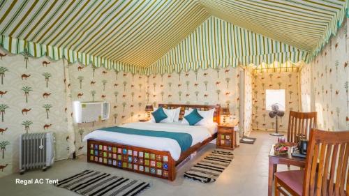 a bedroom with a bed with a striped ceiling at Desert Horizon Luxury Resort &Camp in Jaisalmer