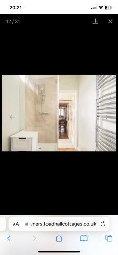a picture of a kitchen with a sink and a room at Snowdrop Cottage in Totnes