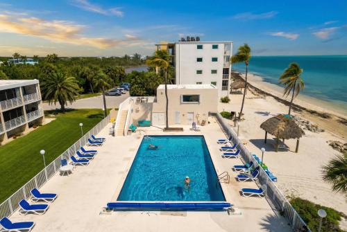 an aerial view of the pool and beach at the resort at Stylish Angler's Retreat, Poolside & Ocean Access #16 in Marathon