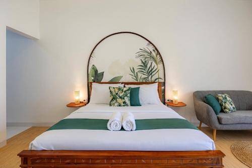 a bedroom with a bed with two slippers on it at Cove Dahayu Sanctuary in Sanur