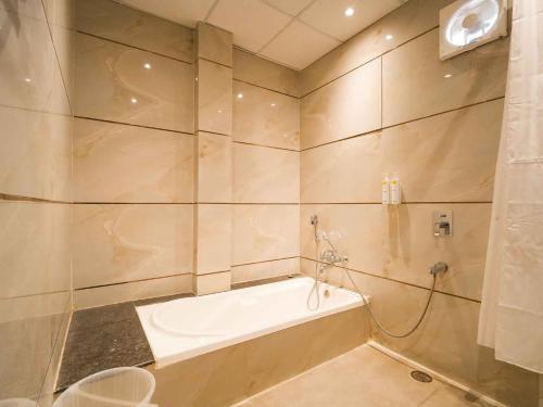a bathroom with a bath tub and a shower at Lemonade Hotel Alwar in Alwar