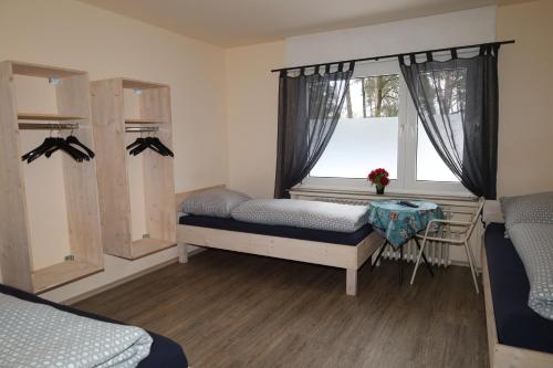 a bedroom with two beds and a window at Pension Highway - Bielefeld Senner Hellweg 227 in Bielefeld