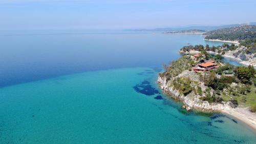 an aerial view of a house on an island in the ocean at Hacienda Beachfront Villa, Spathies in Nikiti