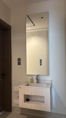 a bathroom with a sink and a large mirror at قوت in Abha