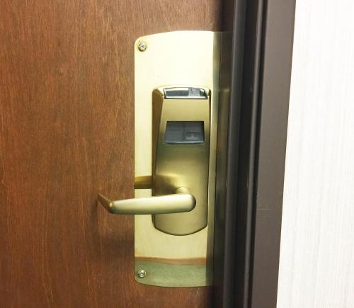 a wooden door with a pay phone on it at Northwoods Inn & Suites Minocqua in Minocqua