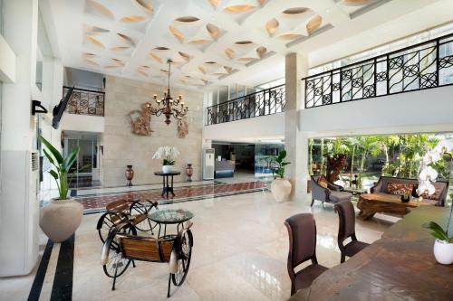 a large living room with a table and chairs at 1O1 URBAN Heritage Yogyakarta Lynn Prawirotaman in Yogyakarta