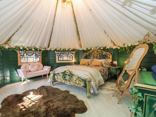 a bedroom with a bed and a tent at Applejacks Orchard in Holywell