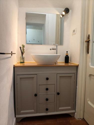 a bathroom vanity with a sink and a mirror at La Voltina in Diecimo