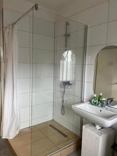 a bathroom with a shower and a sink at Pension Highway - Bünde Carl Diem Straße 46 in Bünde
