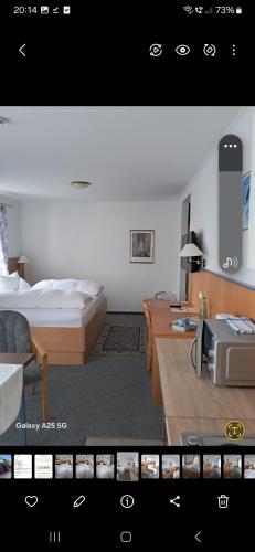 a view of a bedroom with a bed and a desk at Hotel Diekgerdes, in Cloppenburg