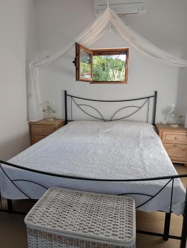 a bedroom with a large bed with a window at Cottage Casa Gina - Goelba in Capoliveri