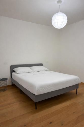 a bed in a bedroom with a white wall at Biancamilla's Home in Giulianova