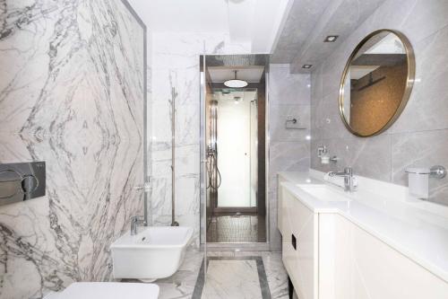 a bathroom with a sink and a toilet and a mirror at Happy Day Apartment, By Cohost in Palanga