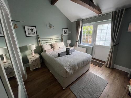a bedroom with a bed and a window at Hollyside Lodge in Carlisle