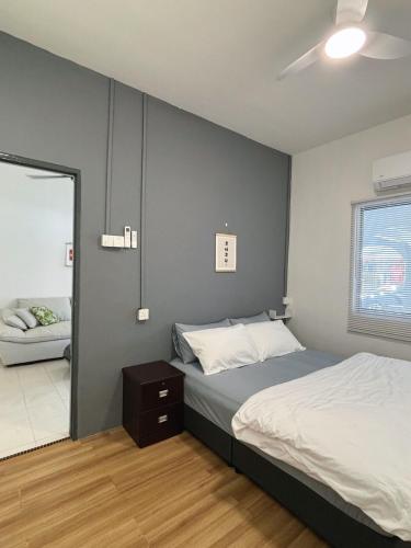 a bedroom with a large bed and a window at Jementah Homestay 18 in Jementah