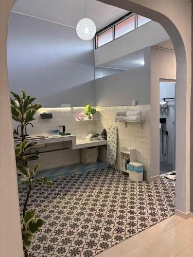 a bathroom with a sink and a desk in a room at Jementah Homestay 18 in Jementah
