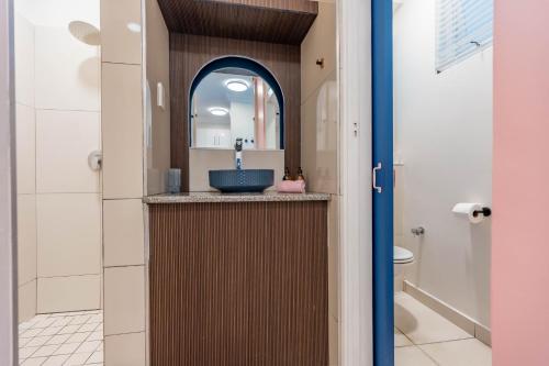 a bathroom with a sink and a toilet at Alfomada in Umdloti