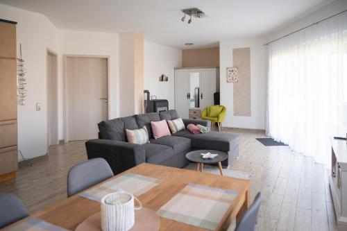 a living room with a couch and a table at Bungalow Klüver in Ueckermünde