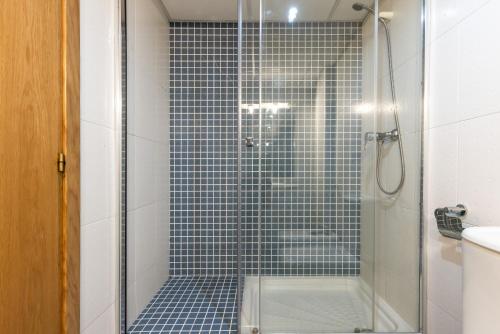 a bathroom with a shower with a glass door at PINEDA NOU Apartments in La Pineda