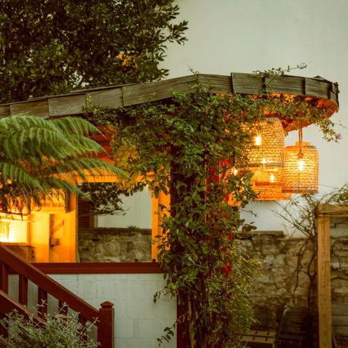 a pergola with a bunch of flowers on it at Hotel Saint Julien in Biarritz