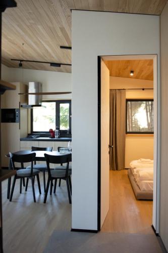 a dining room and kitchen with a table and chairs at Moho in Yablunytsya