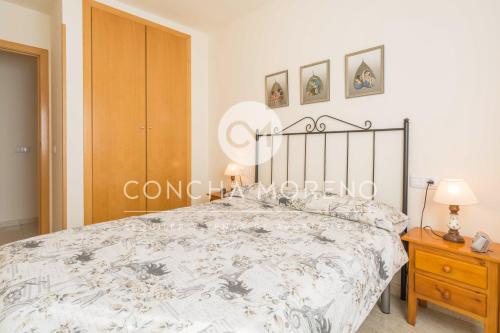 a bedroom with a bed and a wooden cabinet at Señorio de Oropesa-CM in Oropesa del Mar