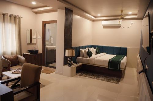 a hotel room with a bed and a bathroom at Hotel Subansiri in Dibrugarh