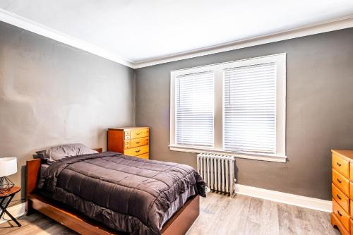 a bedroom with a bed and a window at Orange Queen LLC in East Orange