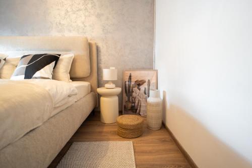 a bedroom with a bed and a table with a rug at Ovideli Apartment in Ocna-Mureşului