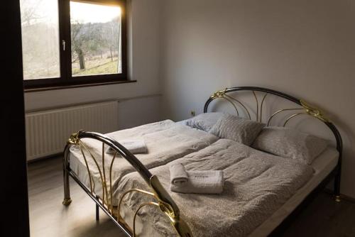 a bed with towels on it in a bedroom at Goričko Homes in Mačkovci