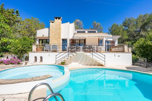a house with a swimming pool in front of a house at Bon Jardi in Esporlas