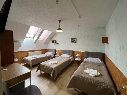 a hospital room with two beds and two windows at Guest House Uzhgorod in Uzhhorod
