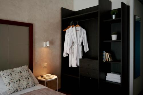 a bedroom with a bed and a black book shelf at Hotel Imperiale in Cattolica