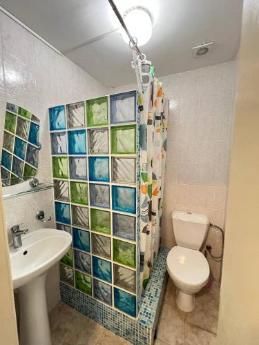 a bathroom with a toilet and a sink at Guest House Uzhgorod in Uzhhorod
