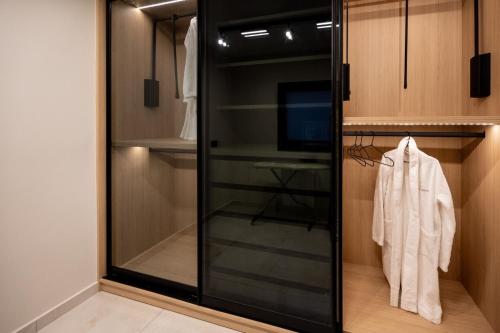 a walk in closet with a glass door at Sunset Dream Luxury Villa in Keri
