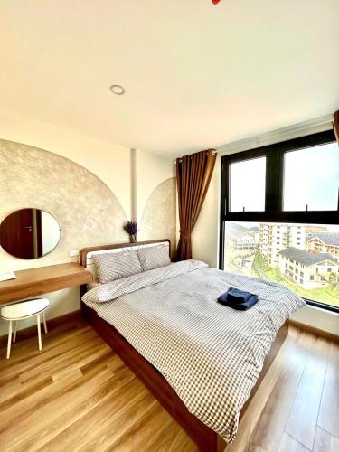 a bedroom with a bed and a large window at Jade's House Sapa - Stunning Views, 3BR, Kitchen & Washer, 5 Min to Town in Lao Cai