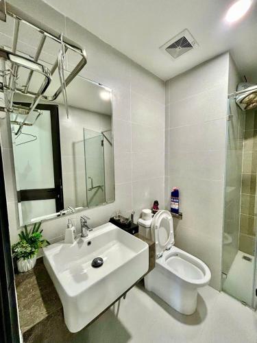 a white bathroom with a sink and a toilet at Jade's House Sapa - Stunning Views, 3BR, Kitchen & Washer, 5 Min to Town in Lao Cai