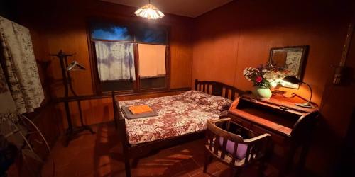 a small room with a table and a piano at Villa Guesthouse Bangkok in Bangkok