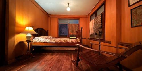 a small bedroom with a bed and a window at Villa Guesthouse Bangkok in Bangkok