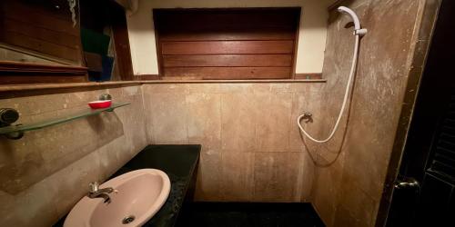 a bathroom with a sink and a toilet and a shower at Villa Guesthouse Bangkok in Bangkok